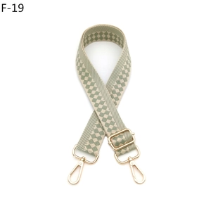 Close-up of adjustable Morandi green checkered bag strap with gold metal lobster clasps