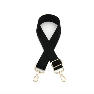 Adjustable black nylon bag strap with gold metal hooks and swivel snap buckles