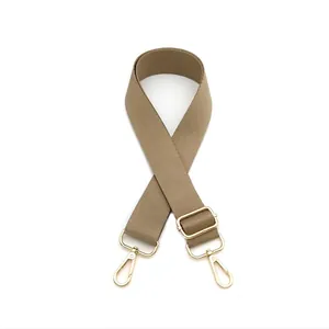 Close-up of khaki adjustable wide bag strap with durable fabric and gold metal buckles