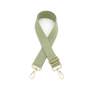 Close-up of light green thickened adjustable bag strap with golden metal hooks