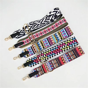 Five adjustable ethnic woven replacement shoulder straps with gold hardware on white background