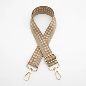 Detail of adjustable beige and brown checkered guitar strap with gold metal hooks