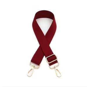 Detail of adjustable wine red thickened shoulder strap with golden metal lobster hooks