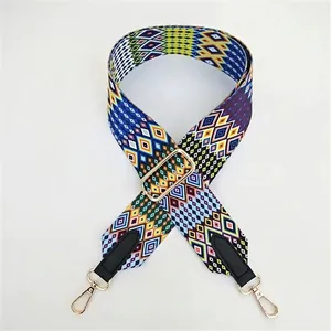 Close-up of geometric jacquard woven strap with golden metal clips and PU leather ends