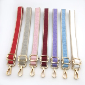 Adjustable woven shoulder straps with geometric patterns and gold metal hardware