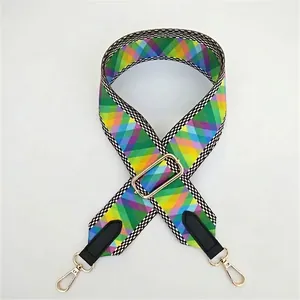 Adjustable wide woven bag strap with colorful geometric patterns and gold metal hooks