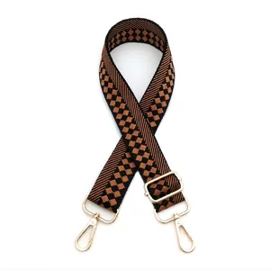 Adjustable checkerboard patterned bag strap with golden metal lobster clasps