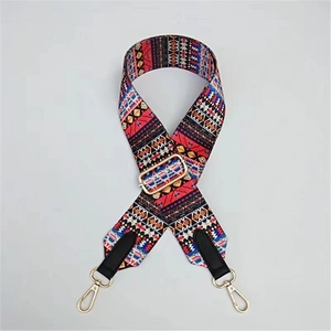 Detail of bohemian geometric woven wide purse strap with golden metal swivel hooks