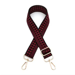 Adjustable checkerboard pattern bag strap with golden buckles on a white background