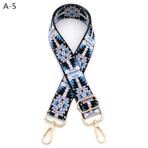 Detail of adjustable geometric ethnic embroidered bag strap with gold metal swivel hooks