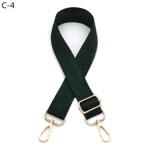 Detailed view of dark green diamond pattern shoulder strap with gold metal hardware