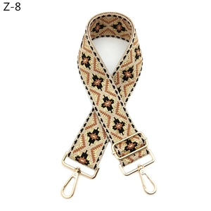 Detail of ethnic geometric wide bag strap with gold lobster clasps and adjustable buckle