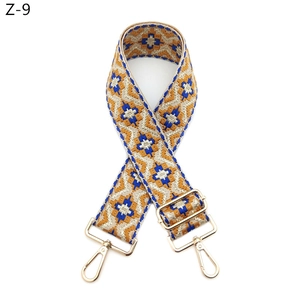 Ethnic style woven strap with yellow geometric patterns and gold metal swivel hooks