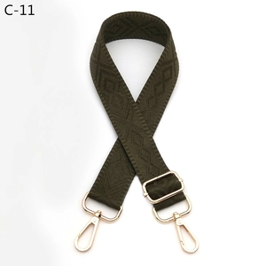 Detail of army green woven shoulder strap with geometric diamond texture and gold buckle