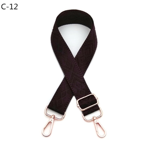 Detail of purple diamond pattern bag strap with rose gold metal swivel hooks and adjuster