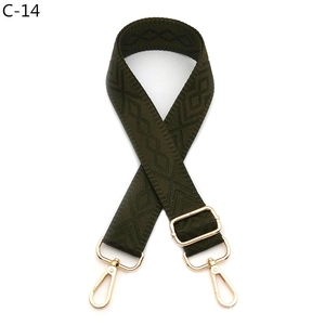 Detail view of olive green rhombus pattern strap with adjustable golden metal buckles