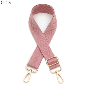 Detail of adjustable rose pink wide shoulder strap with diamond pattern and gold hardware