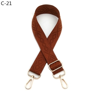 Detail of brown quilted woven strap with gold alloy lobster clasps and adjustment buckle