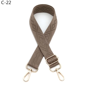 Detail of adjustable khaki geometric diamond weave strap with light gold metal lobster clasps