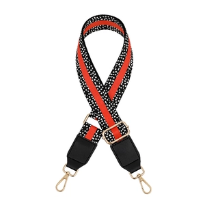 Adjustable leopard print bag strap with red stripes and gold metal hooks on white background