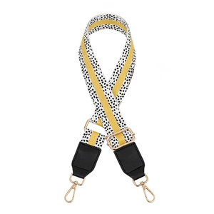 Close-up of leopard pattern bag strap with yellow stripe and gold metal hooks