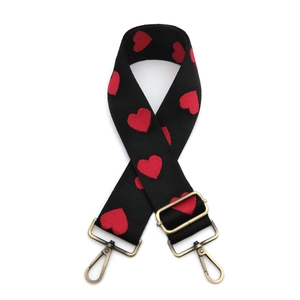 Adjustable black strap with red heart jacquard pattern and bronze metal buckles