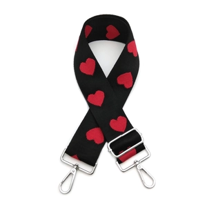 Adjustable black knit shoulder strap featuring red heart patterns and silver metal buckles