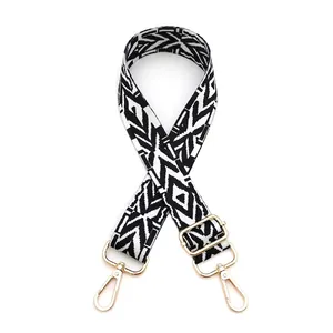 Macro detail of bohemian black and white geometric woven strap with gold metal buckles