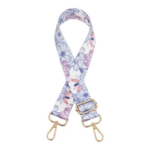Adjustable bag strap featuring blue and purple floral print with gold metal swivel hooks