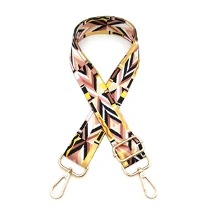 Detail of bohemian geometric woven bag strap with light gold metal swivel snap hooks