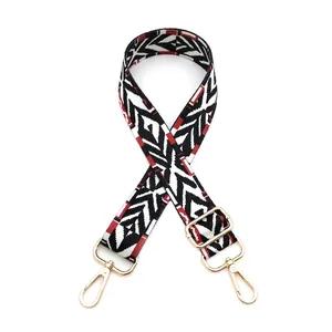 Detail view of ethnic style No. 8 woven bag strap with red geometric pattern and gold clips
