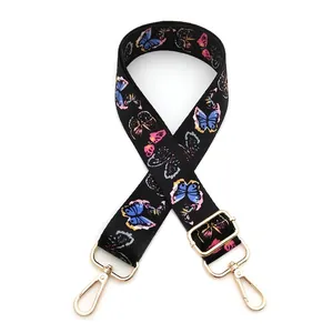 Adjustable bag strap featuring colorful butterfly prints and gold metal swivel hooks