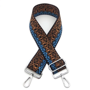 Adjustable geometric embroidery bag strap with silver metal hooks on white background