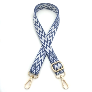 Adjustable blue and white geometric woven shoulder strap with gold metal lobster clasps