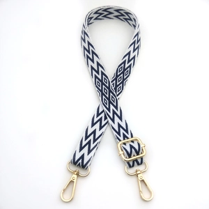 Detail of adjustable woven blue wave strap with gold metal lobster clasps for bags