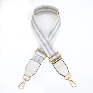Detail of adjustable white strap with silver sequins and gold-tone metal hooks