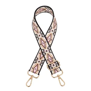 Detail of bohemian geometric woven bag strap with golden metal lobster clasps