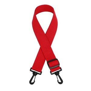 Detail of red nylon shoulder strap with black swivel hooks and adjustable plastic buckle