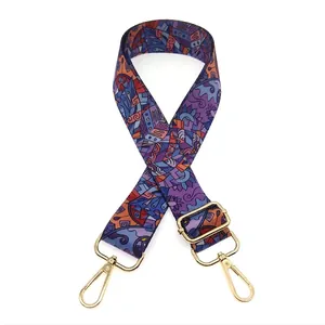Close-up of adjustable woven bag strap with colorful bohemian patterns and gold hardware