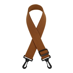 Detail view of brown woven bag strap with adjustable plastic buckle and swivel hooks