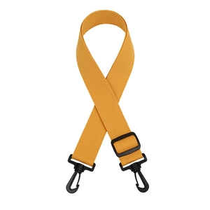 Detail of yellow high-density polyester bag strap with matte black plastic hooks and buckles