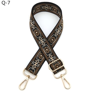 Close-up of ethnic embroidered adjustable wide purse strap with gold lobster clasps