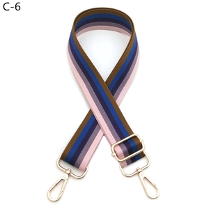 Close-up of adjustable colorful striped nylon shoulder strap with gold metal hooks