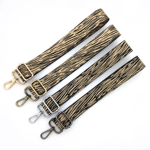 Adjustable bark pattern bag strap with gold, silver, bronze, and grey metal hardware