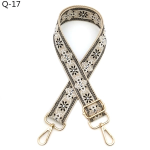 Close-up of ethnic style adjustable bag strap with black and white floral woven pattern