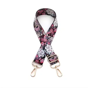 Close-up of ethnic style replacement strap with colorful patterns and gold lobster clasps