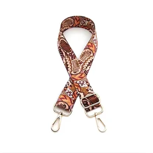 Detail of adjustable ethnic style strap with geometric patterns and gold metal hooks