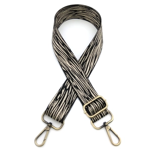 Detail of adjustable animal print bag strap with retro bronze metal lobster clasps
