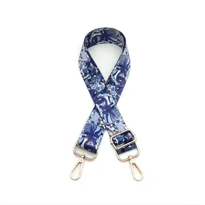 Detail of adjustable blue ethnic canvas strap with gold metal buckles and lobster clasps