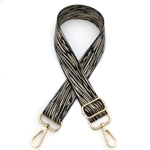 Adjustable crossbody shoulder strap with bark pattern texture and gold hardware hooks